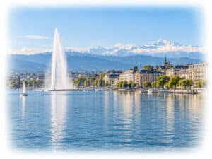 Jet d’Eau, Lake Geneva waterfront and Alpine skyline viewed across the water